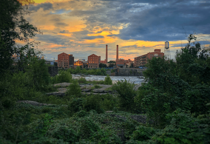 A green landscape along the river across from the skyline of Columbus, Georgia