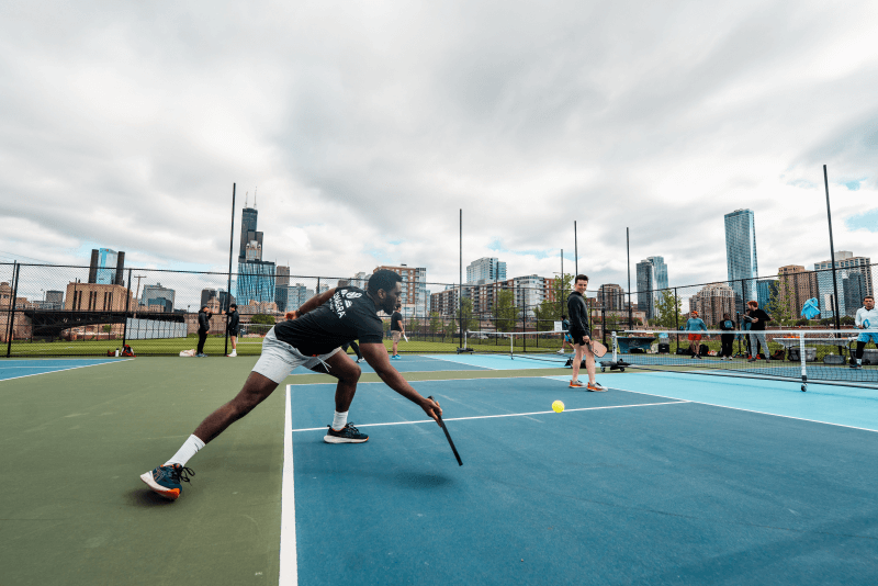 Members of Court Culture play pickleball while surrounded by skyscrapers in downtown Chicago