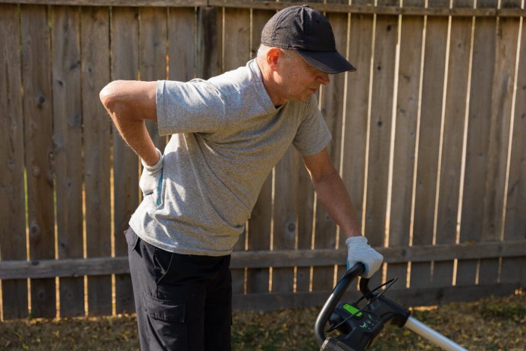 A man with an injured back doing yard work